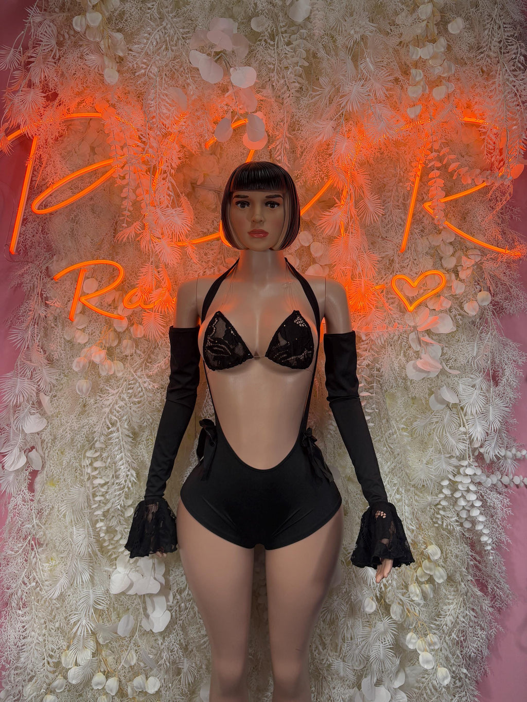 Black lace one-piece with deep V neckline, long sheer sleeves and heart trim