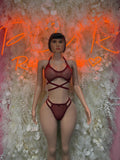Red strappy one-piece rave bodysuit with crisscross front
