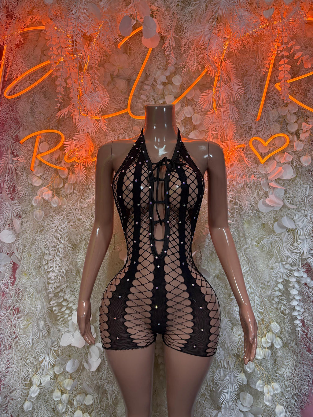 Black fishnet bodysuit with high neckline, sleeveless cut, and vertical panel design