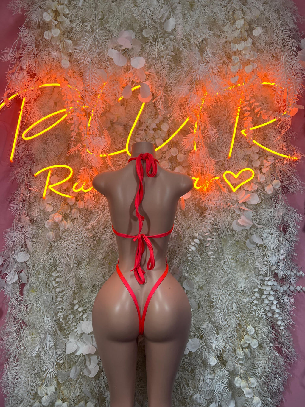 Coral fishnet backless bodysuit with crisscross straps and thong bottom
