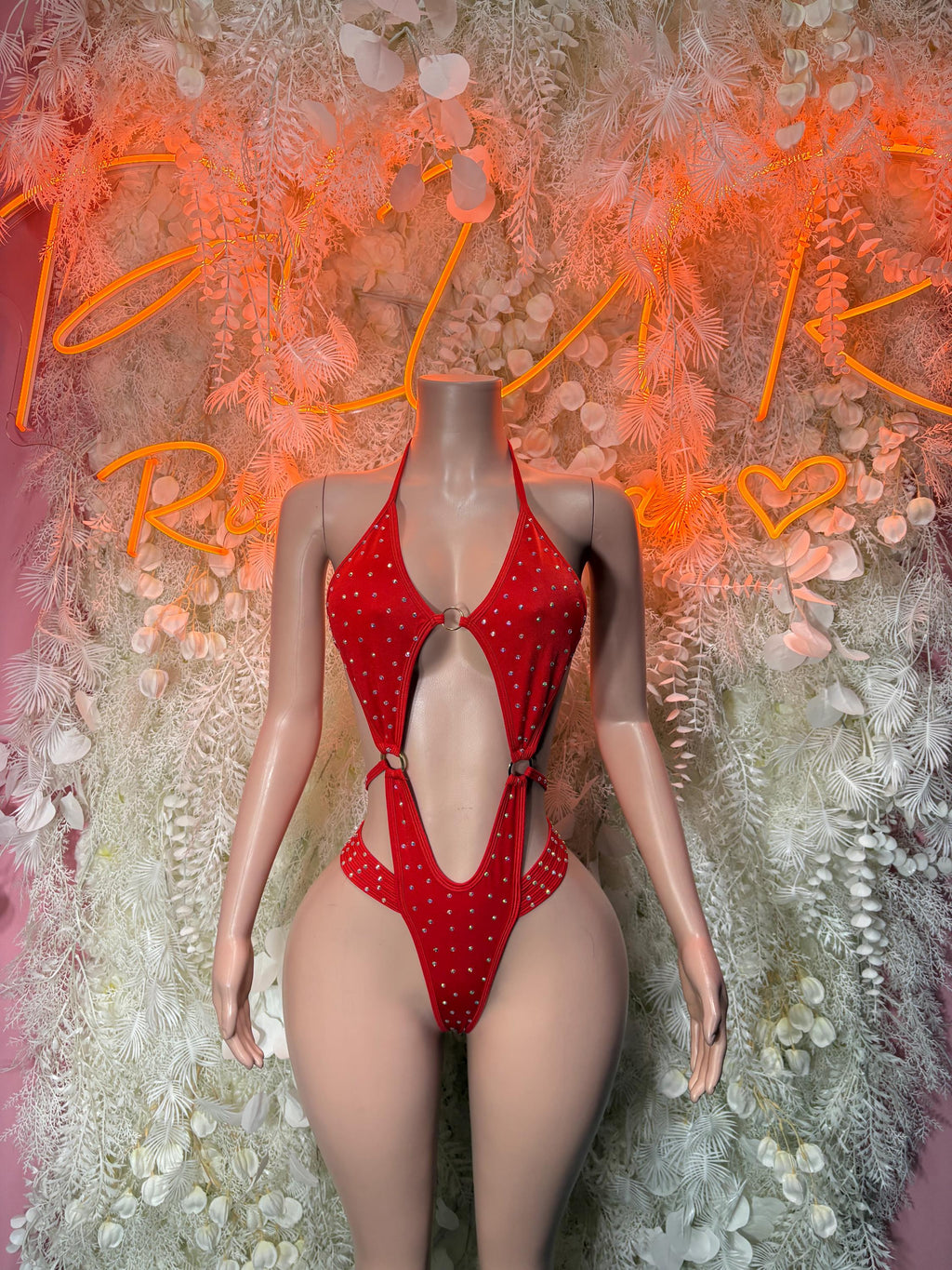 Red rhinestone one-piece bodysuit with halter straps and high-cut front