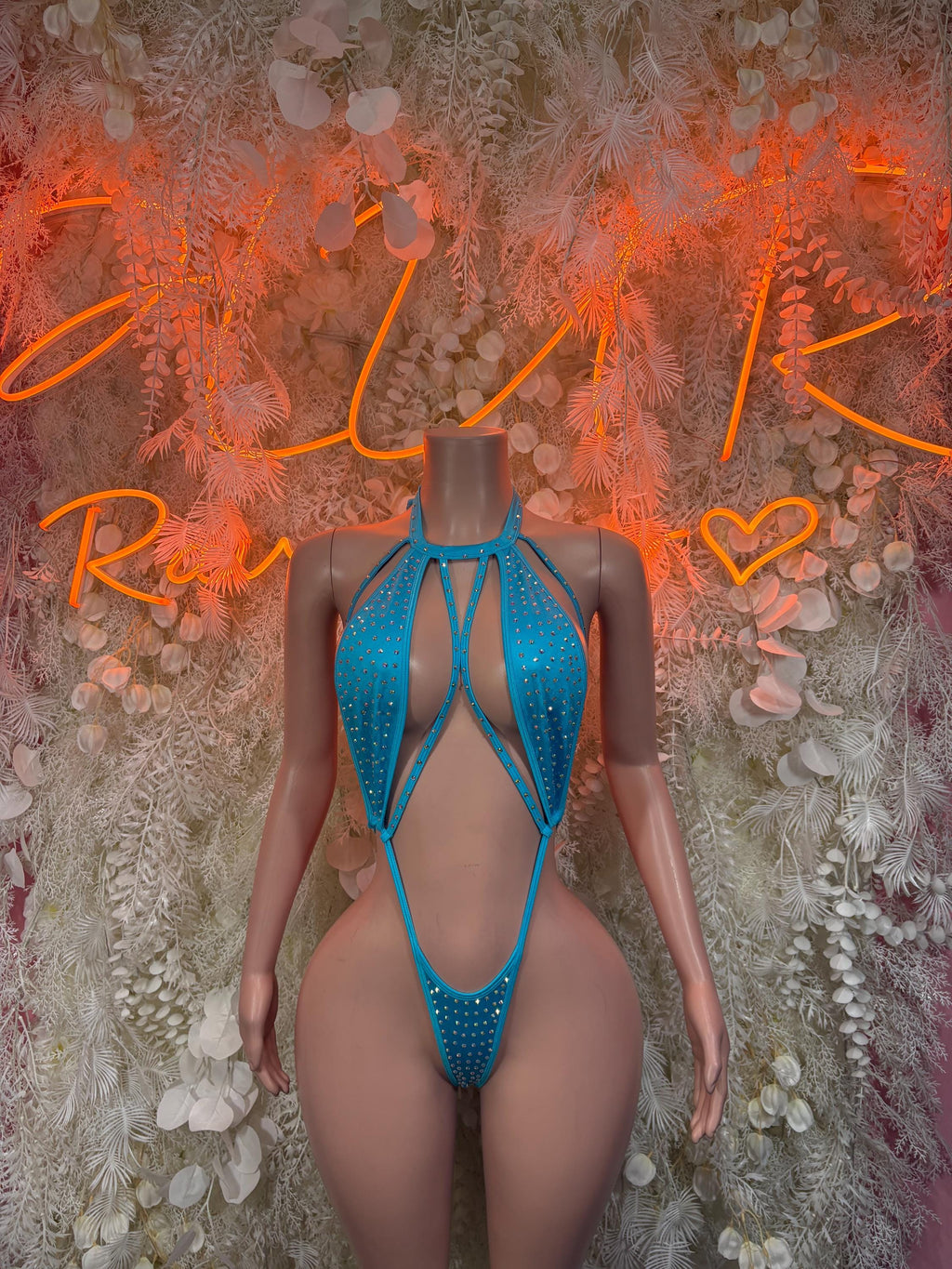 Blue rhinestone one-piece swimsuit with open-back cutout and crisscross straps.