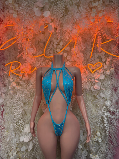 Blue rhinestone one-piece swimsuit with open-back cutout and crisscross straps.