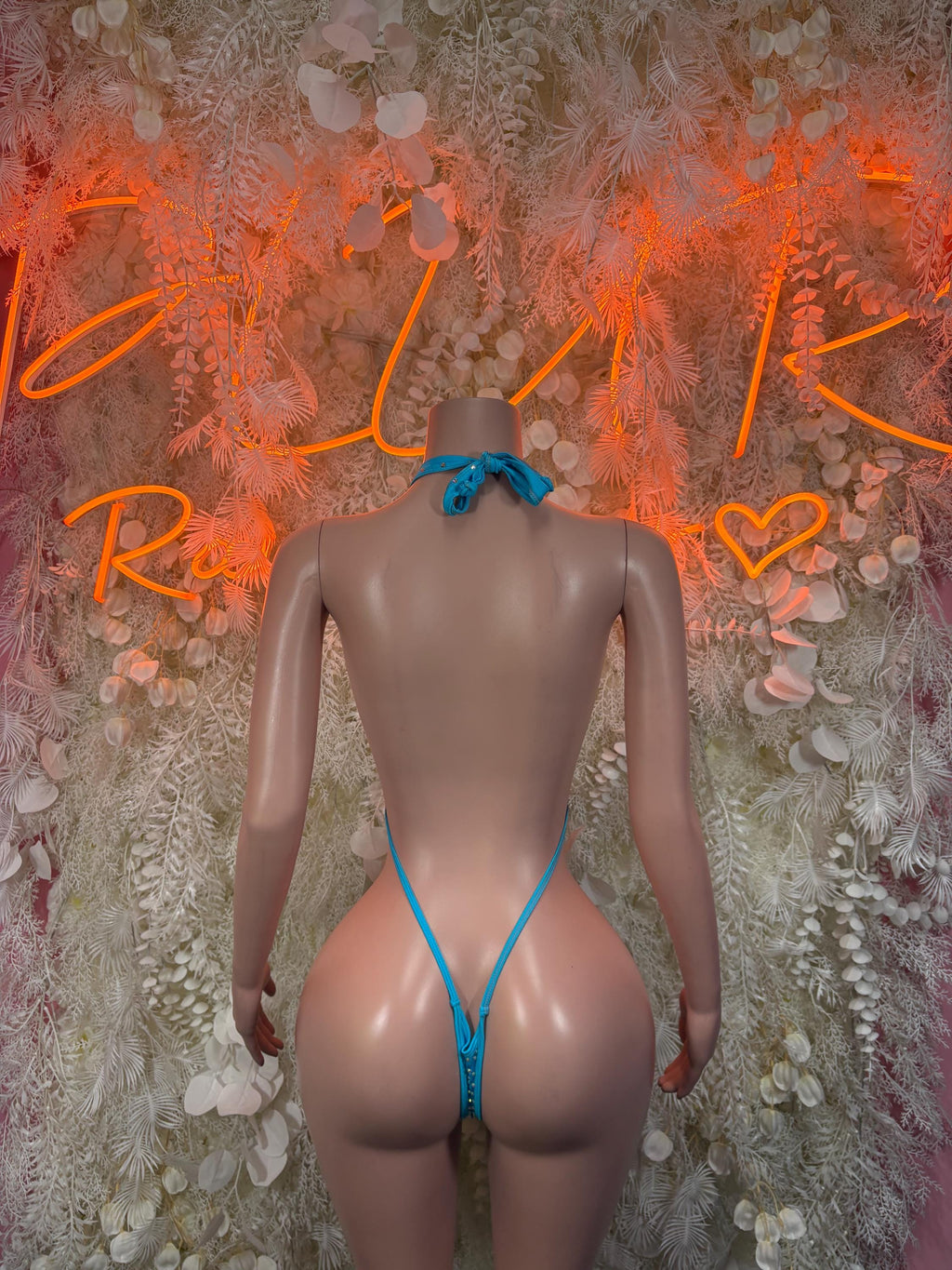 Blue rhinestone one-piece swimsuit, back view with thin straps and cheeky cut.