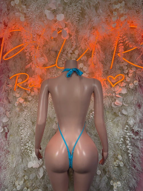 Blue rhinestone one-piece swimsuit, back view with thin straps and cheeky cut.