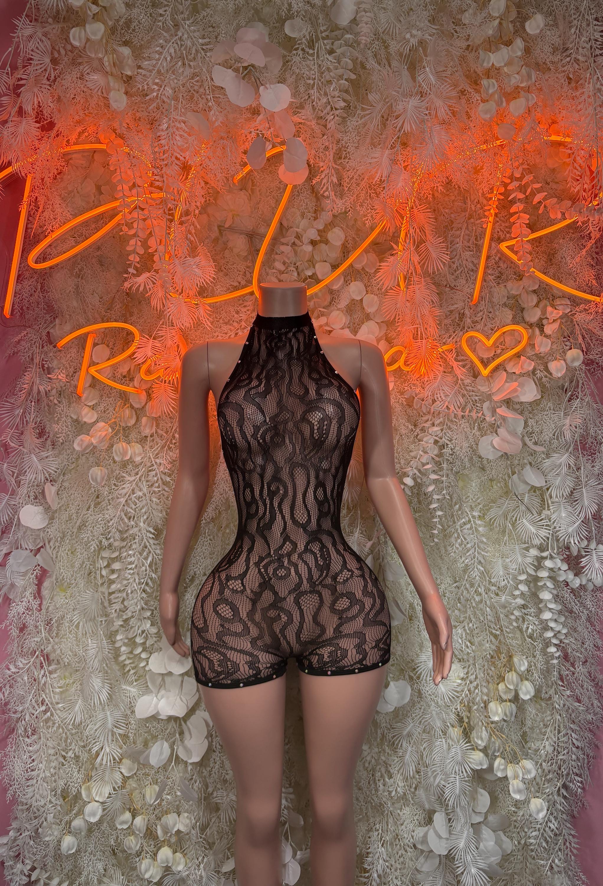 Black high-neck fishnet romper with short legs and lace-like sculpted pattern