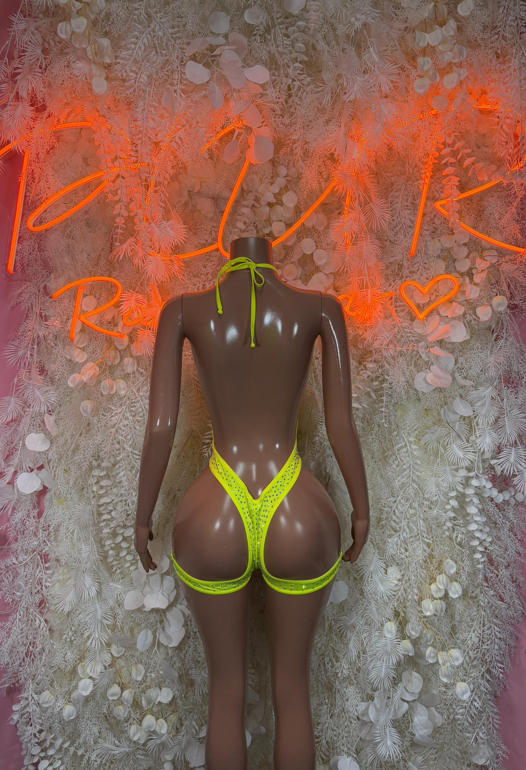 Neon green one-piece bodysuit with low-back V cut and thong-style bottom
