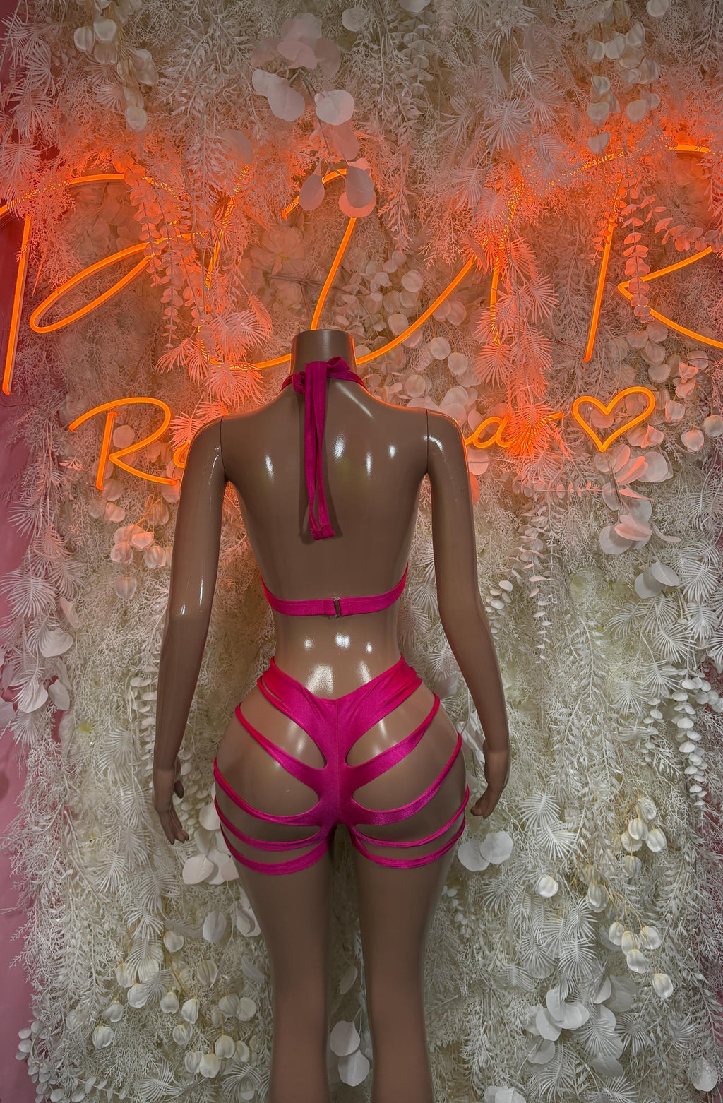 Pink cutout two-piece rave set with triangle bra and strappy high-rise shorts, back