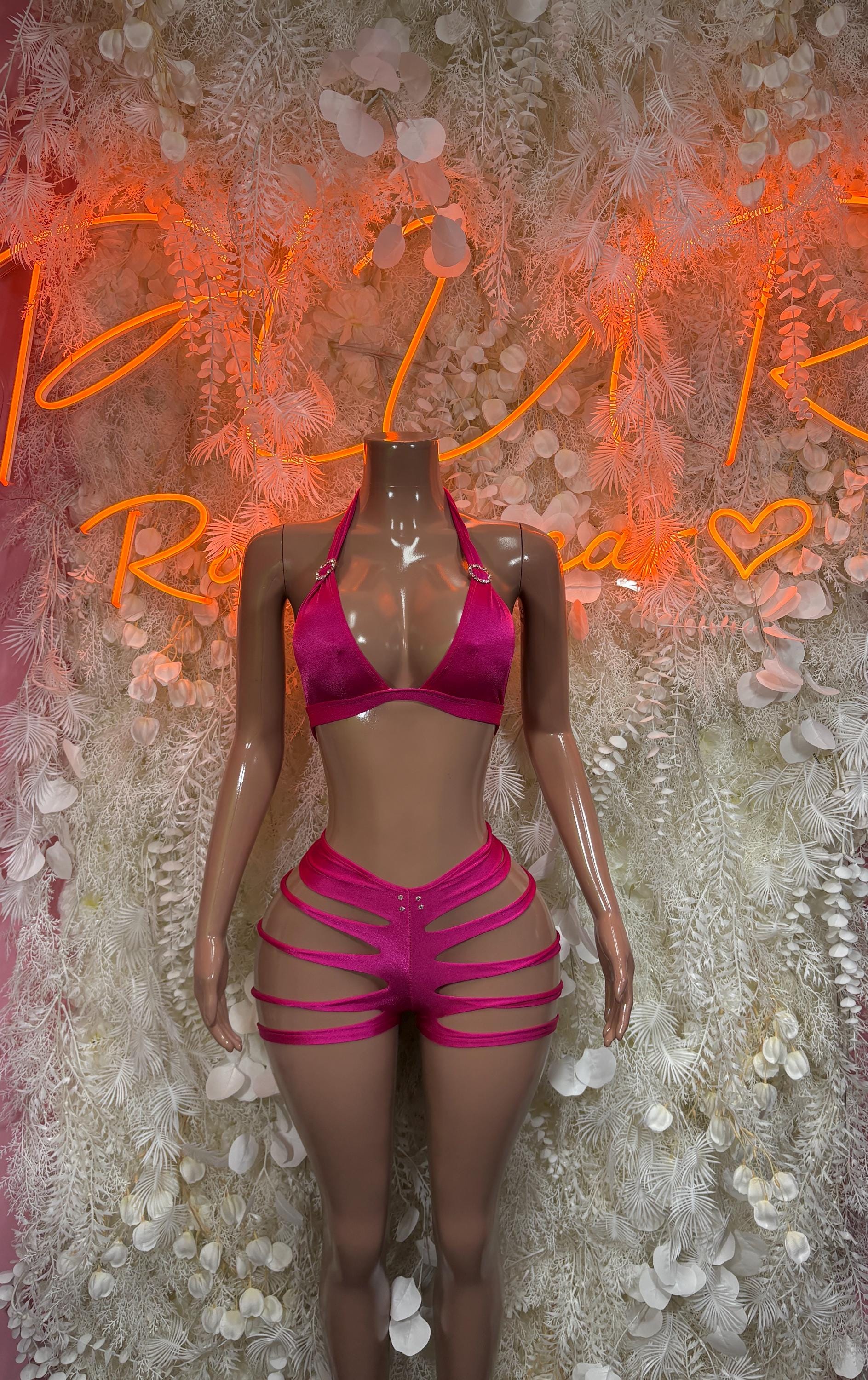 Pink cutout two-piece rave set with triangle bra and strappy high-rise shorts, front