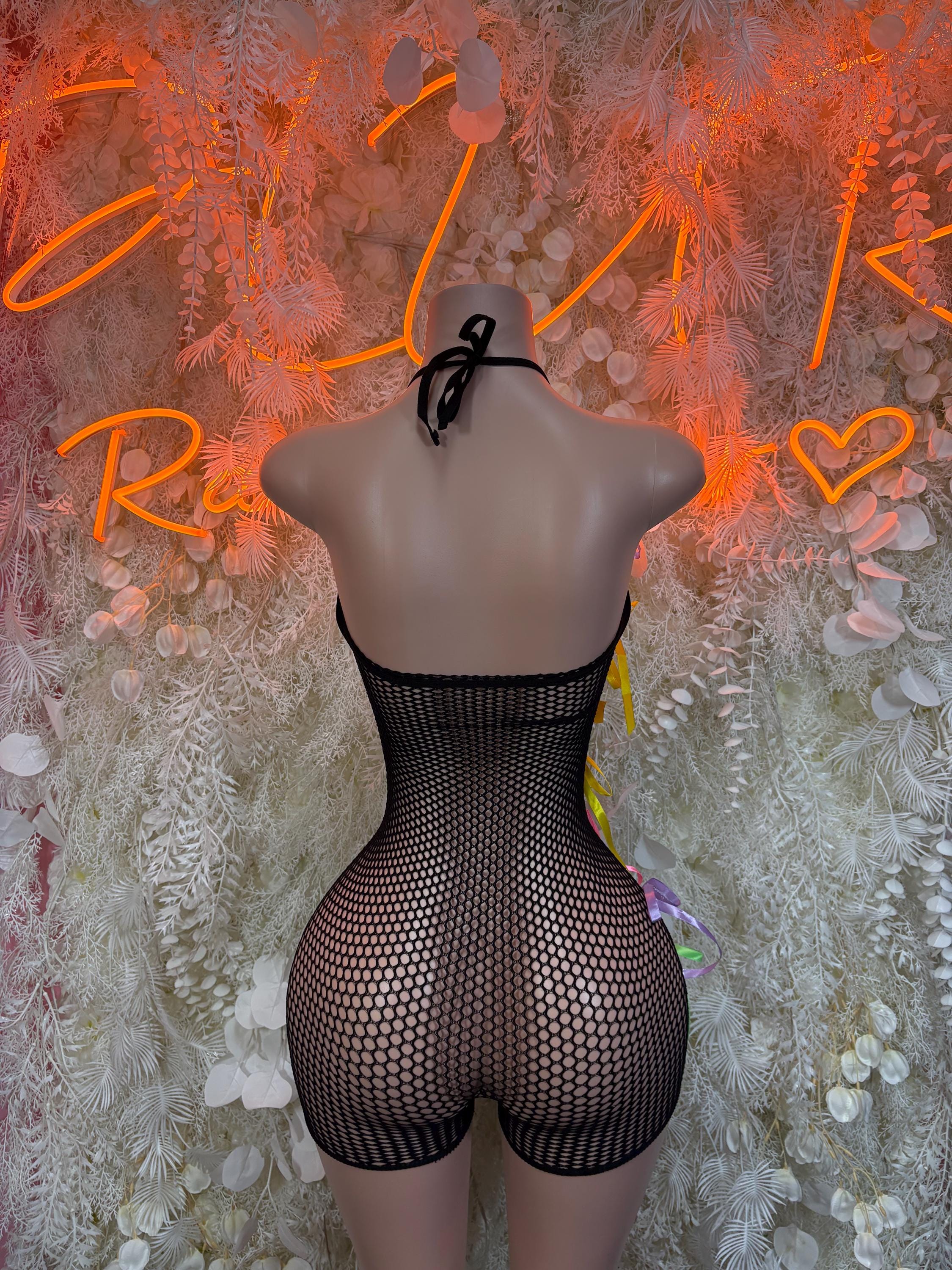 Black fishnet one-piece with open back and multicolor ribbon ties at waist