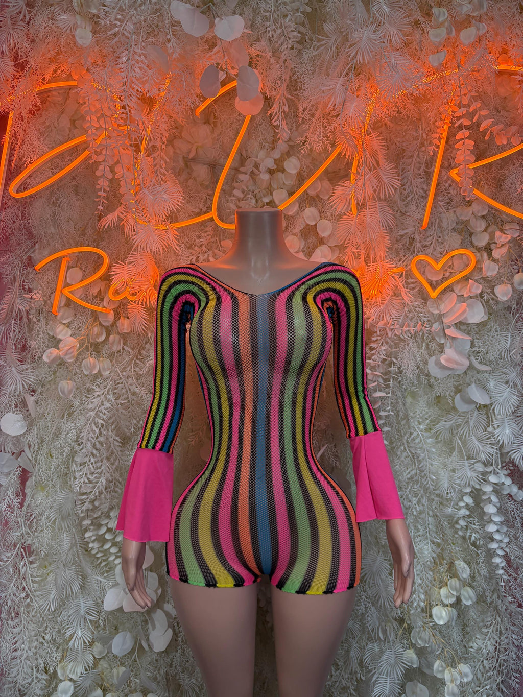 Multicolor striped one-piece romper with long flared sleeves and pink accents