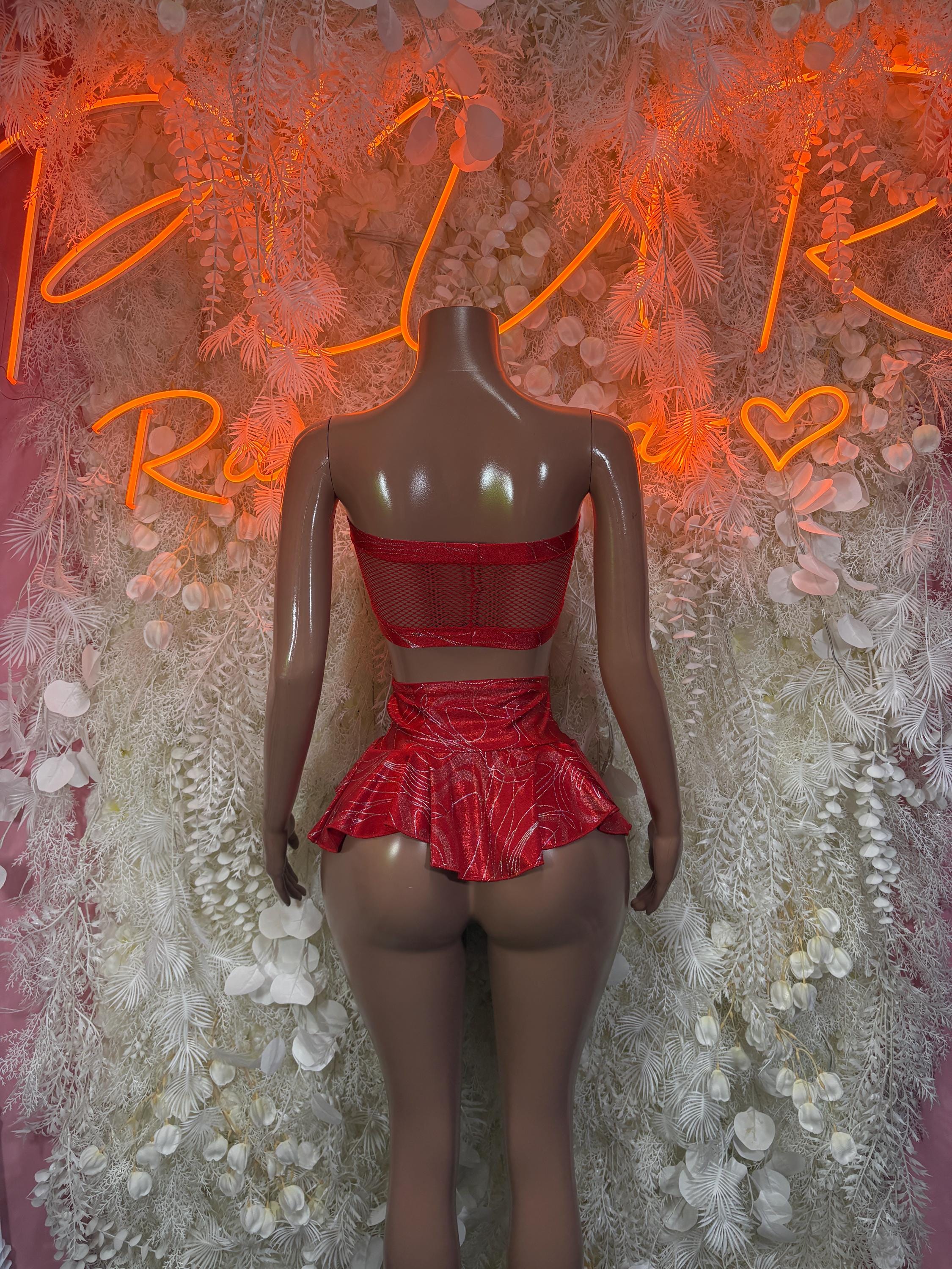 Red two-piece skirt set with mesh bandeau top, lace-up back, and ruffled mini skirt