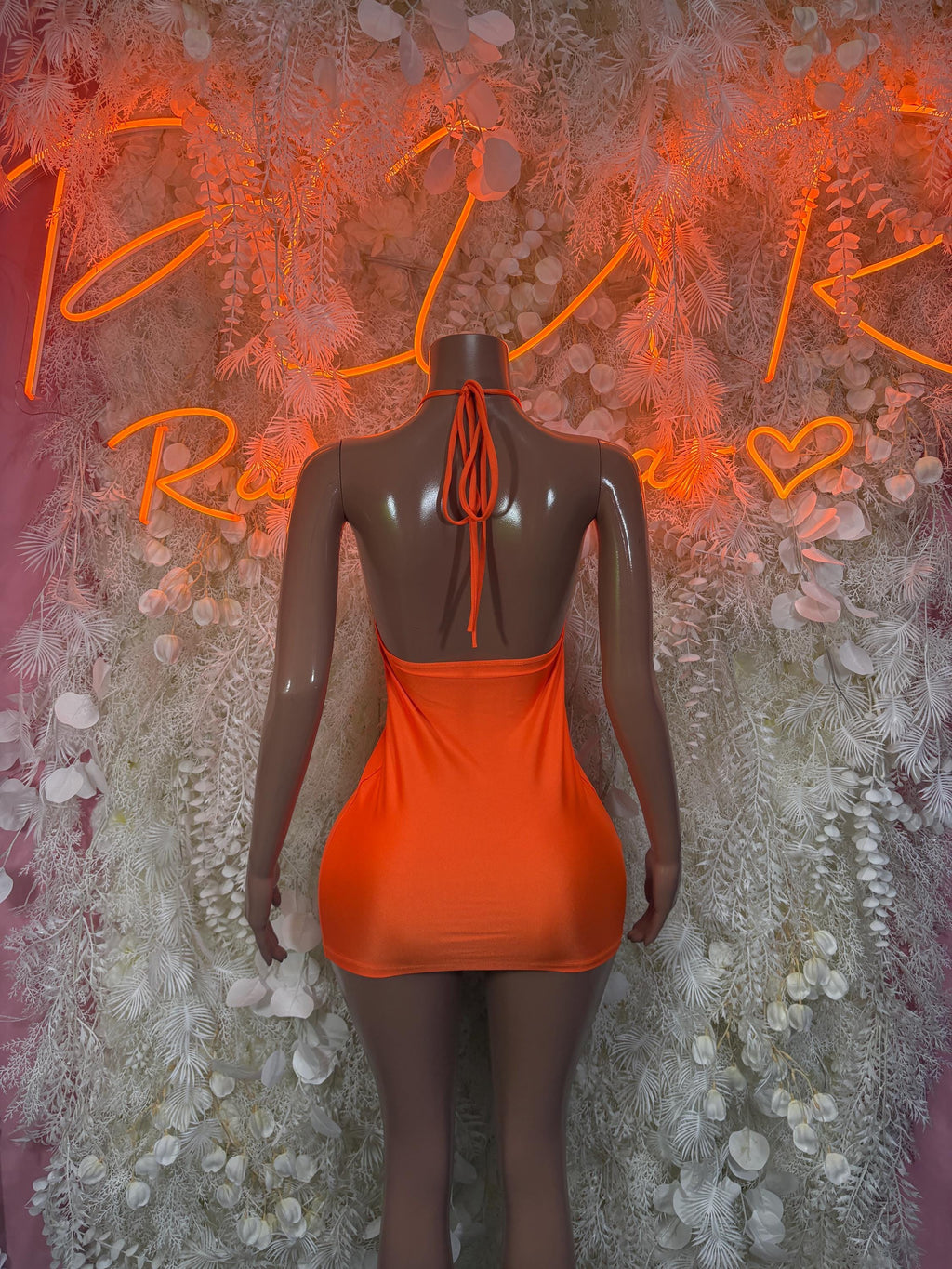 Orange sleeveless mini dress with open back and crisscross strap detail