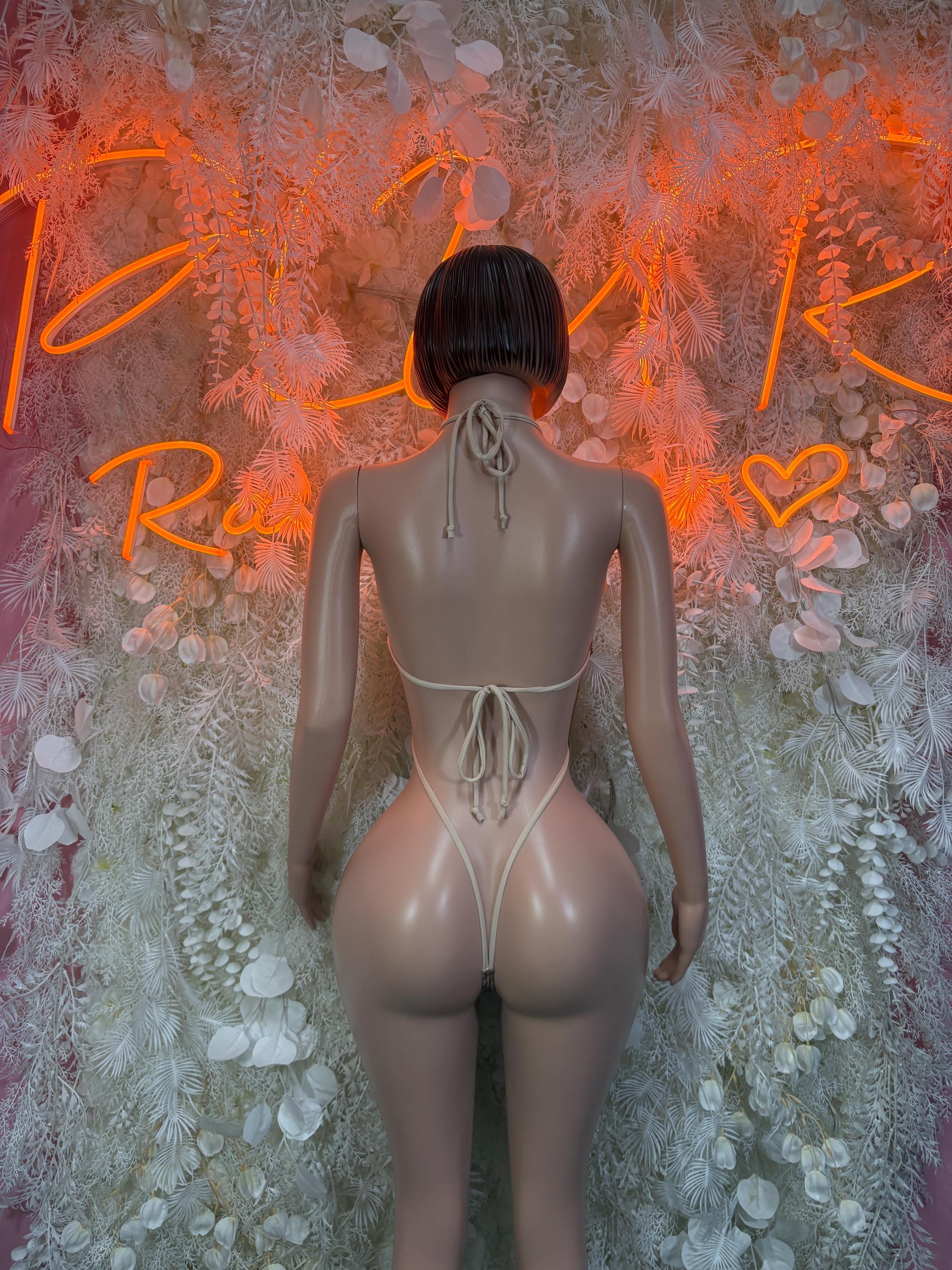 Back view of gold rhinestone bodysuit with thin tie strings at waist