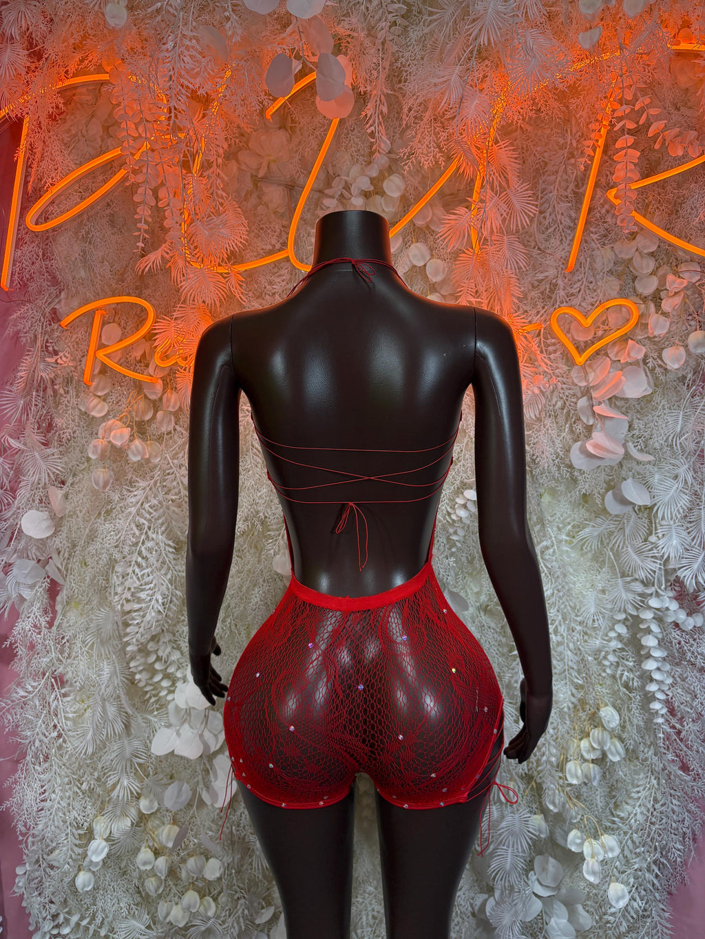 Red fishnet bodysuit with open-back panel and high-rise shorts, back view
