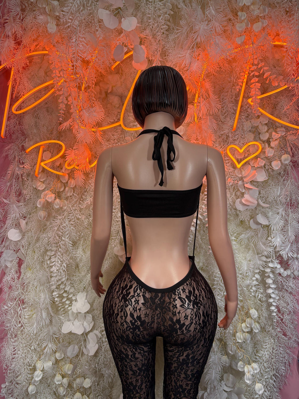 Black fishnet bodysuit back view with tie at neck and lace high-waist legs