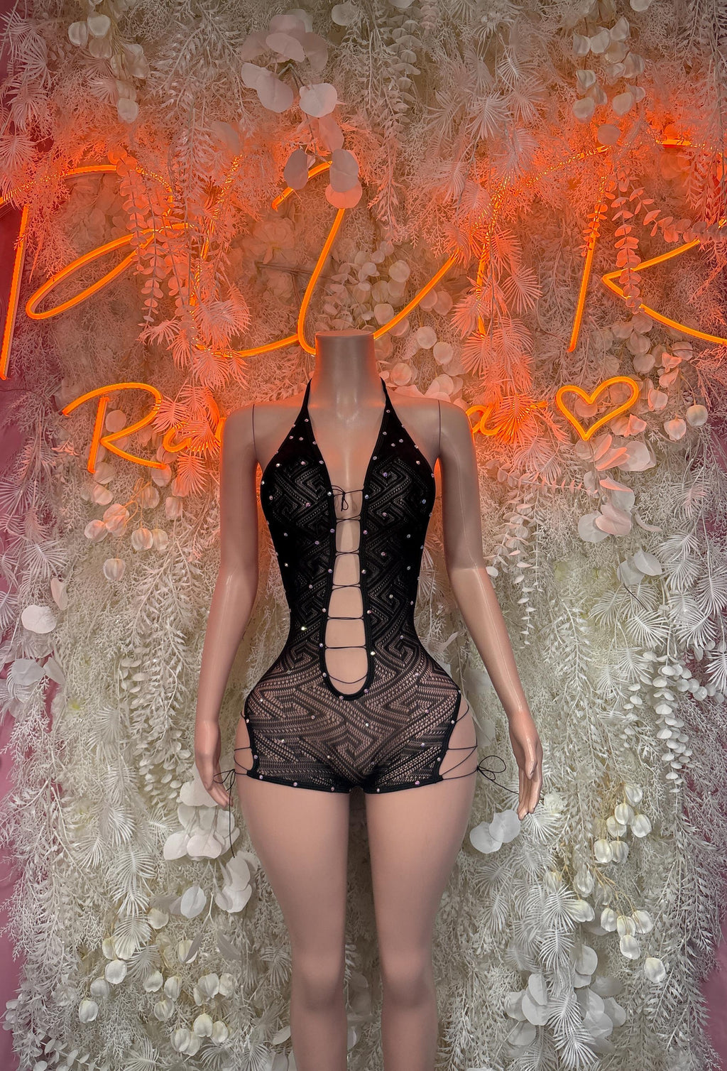 Fishnet black one-piece bodysuit with front lace-up strappy neckline, short legs