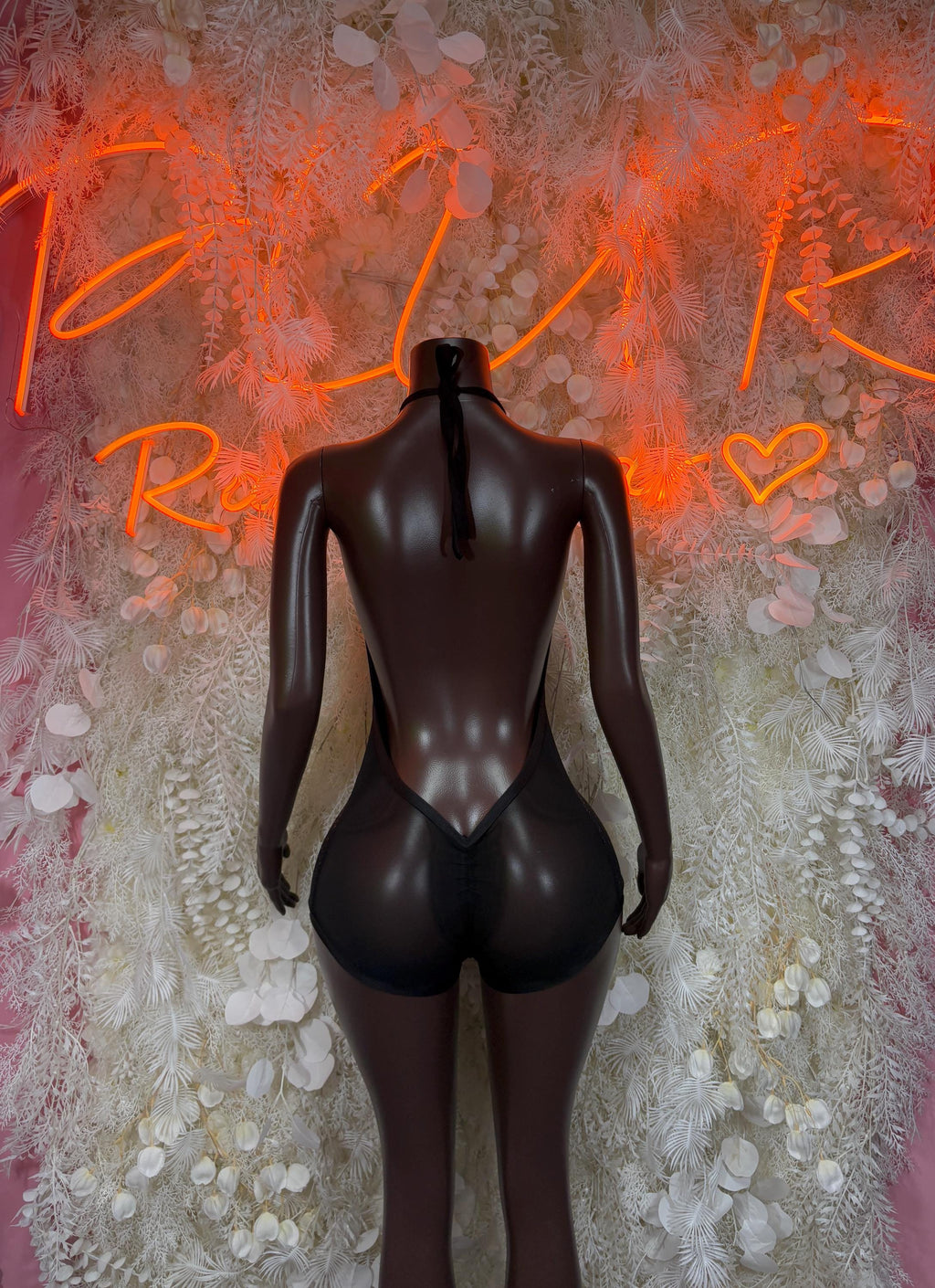 Black rhinestone one-piece bodysuit with open back and high-cut legs