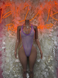 Purple fishnet one-piece swimsuit with thin straps and high-cut leg openings