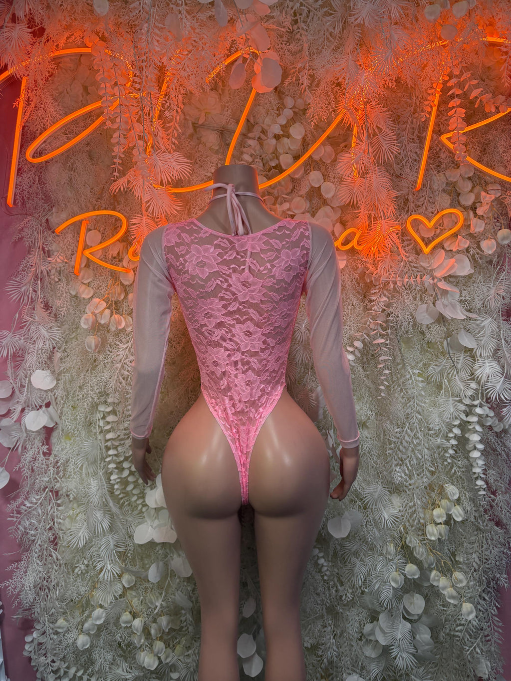 Pink lace long-sleeve bodysuit with lace-up back and high-cut leg openings