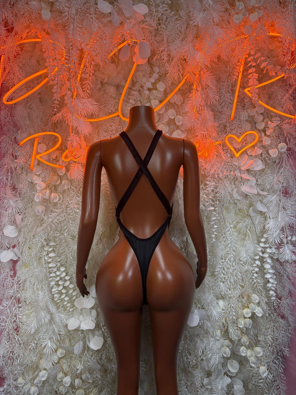 Black festival bodysuit with crisscross X-back straps and low scoop neckline