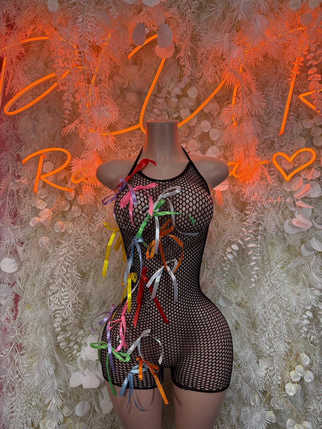 Black fishnet one-piece bodysuit with multicolor ribbon tassels at front