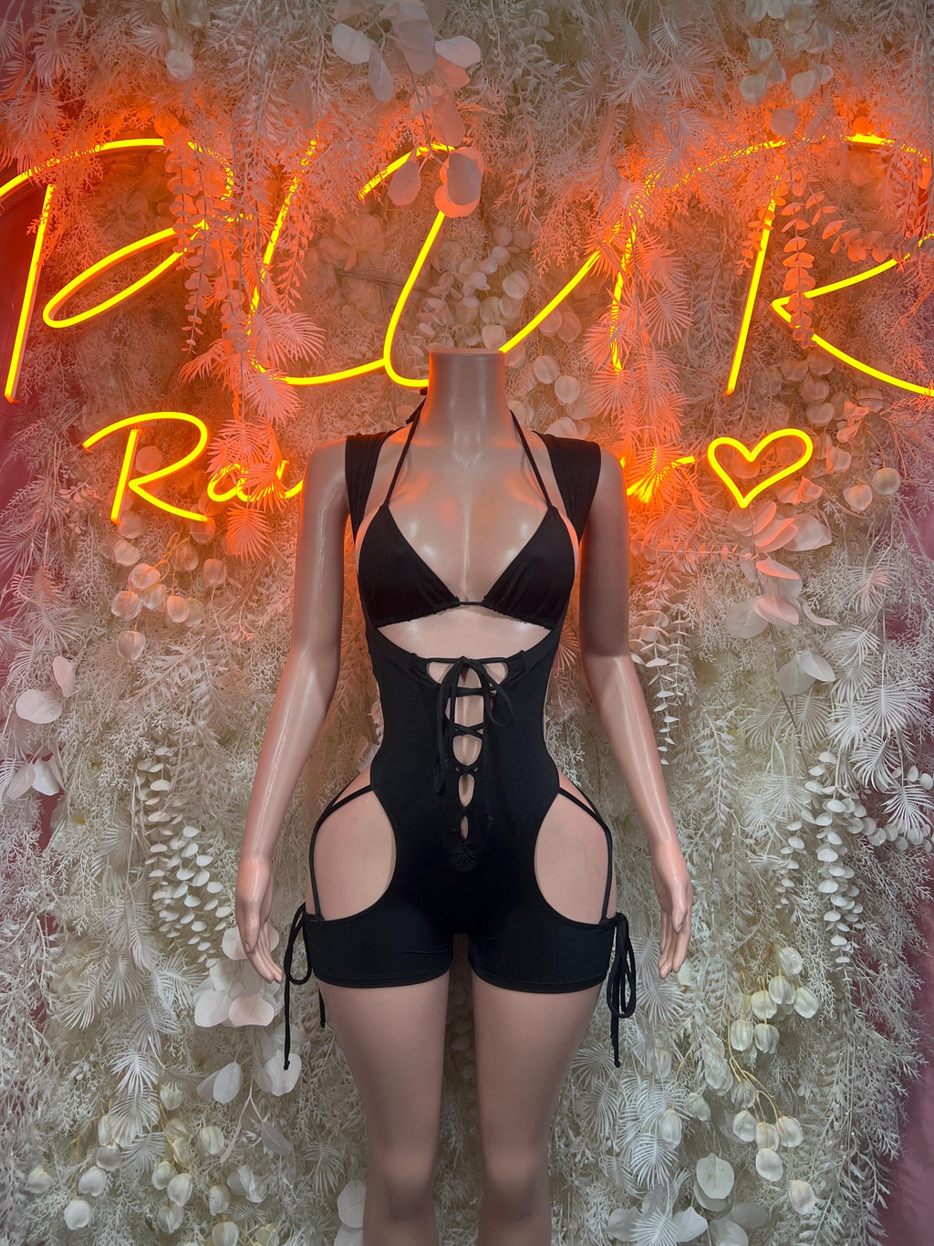 Black sleeveless bodysuit with lace-up front, cutout panels, and adjustable tie straps