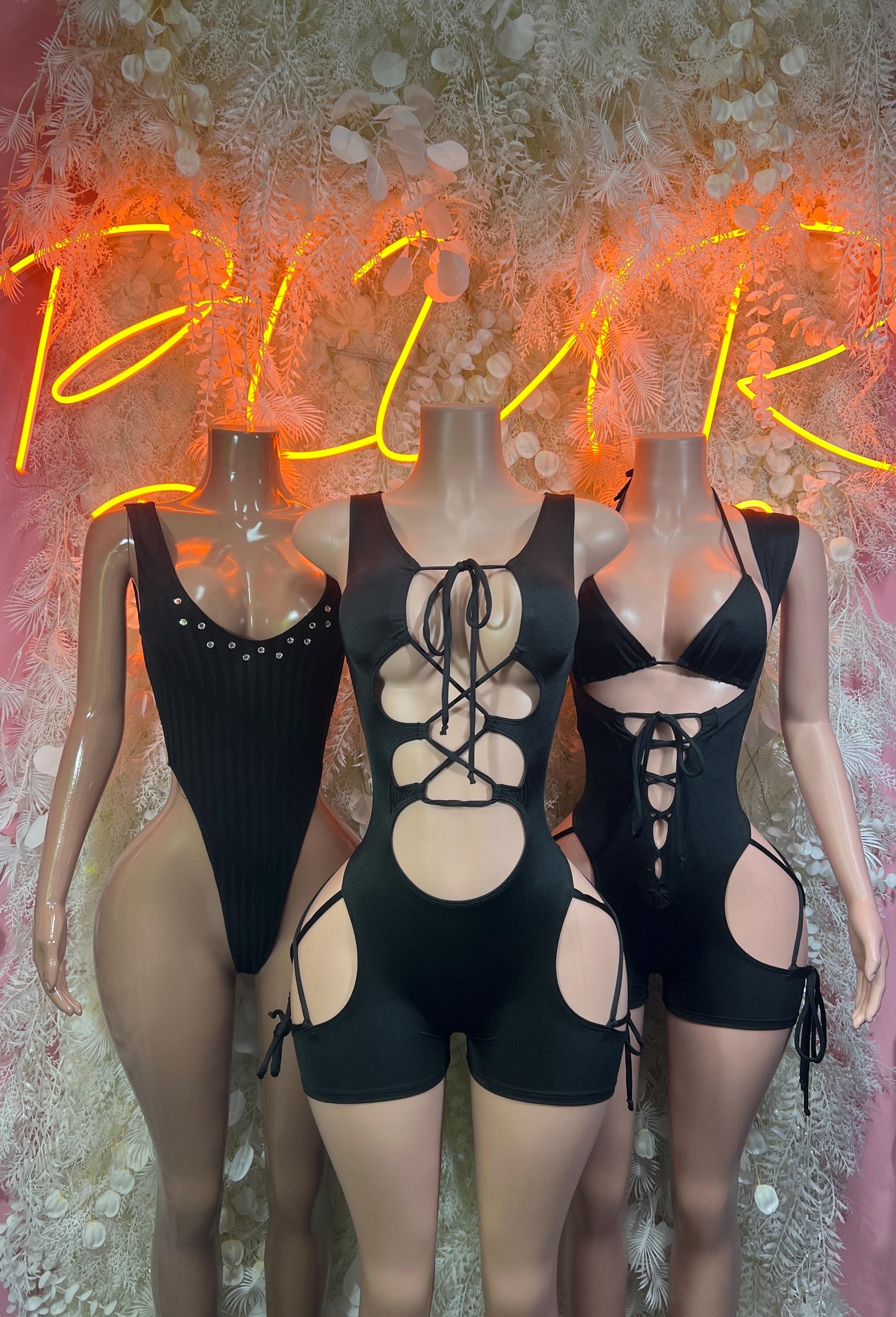 Black lace-up rave bodysuit set with front cutouts, garter straps, and thigh openings