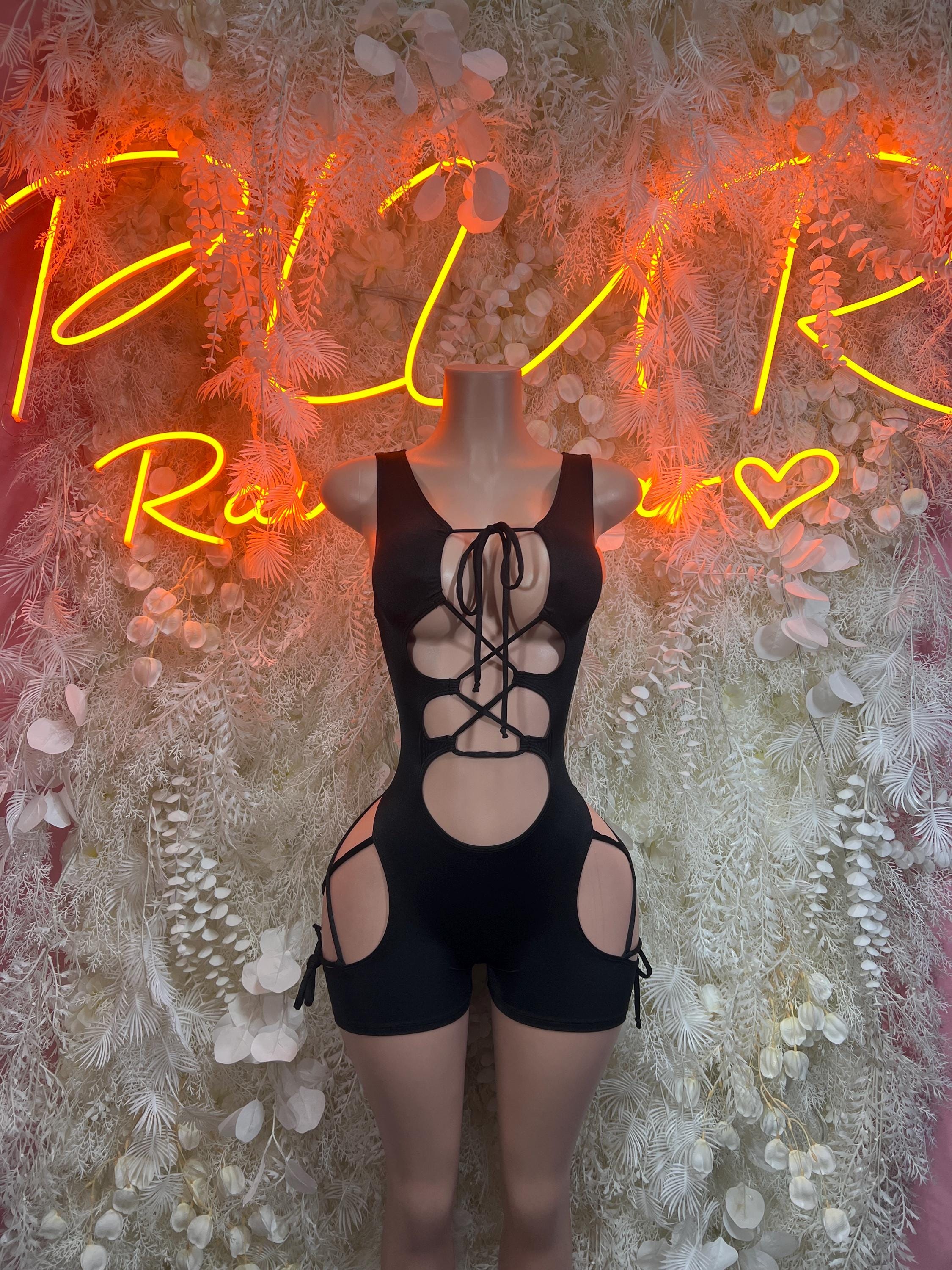 Black lace-up bodysuit with halter straps, open front cutouts and garter shorts