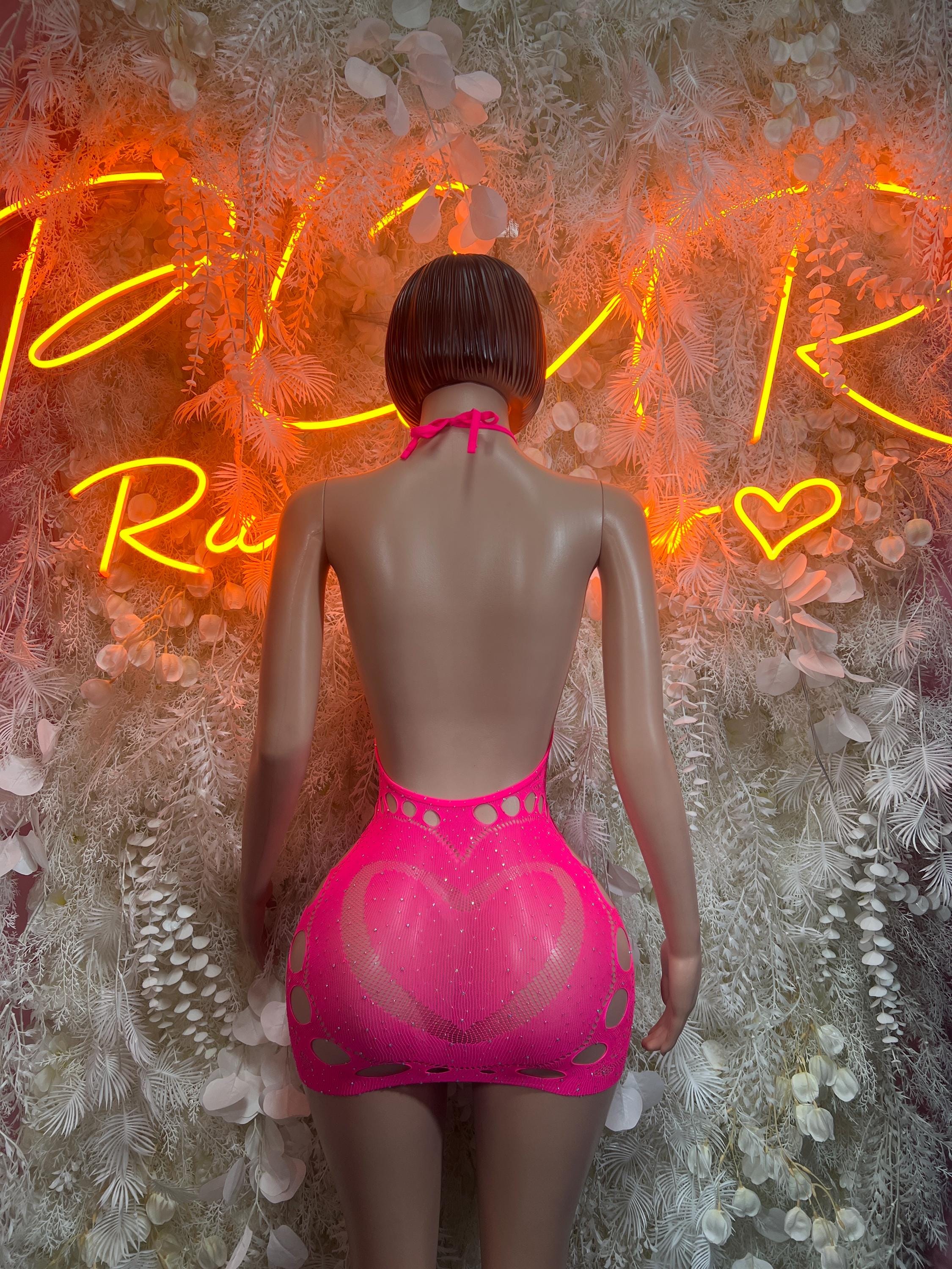 Pink fishnet backless bodysuit with strappy back and keyhole detail