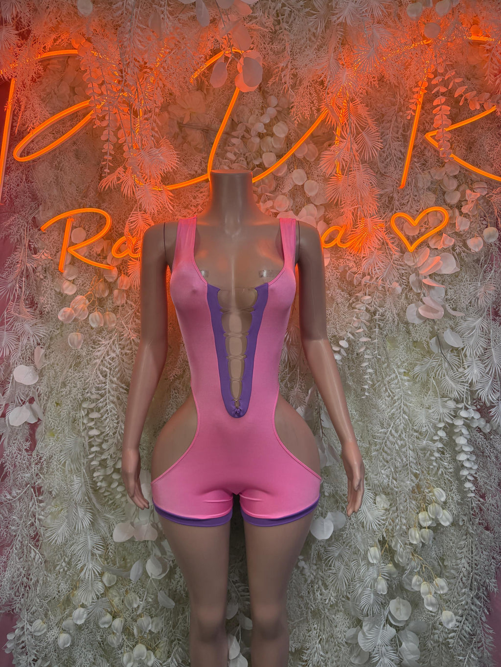 Pink high-cut rave bodysuit with wide straps and center cutout