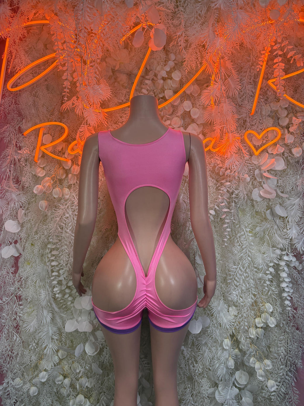 Pink rave bodysuit with high-leg cut and V-shaped front panel