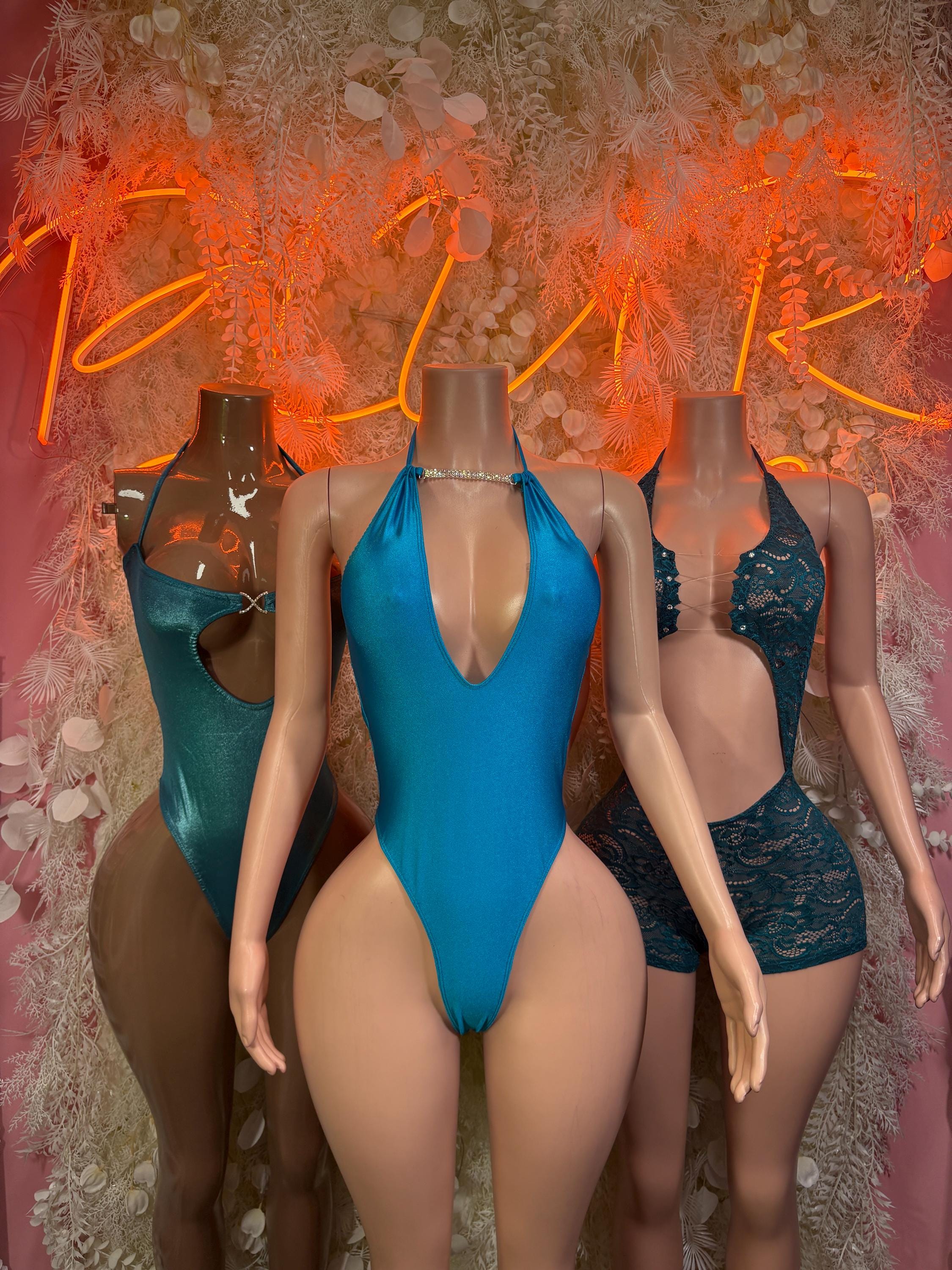 Aqua blue lace bodysuit with halter neckline and open back, plunging front
