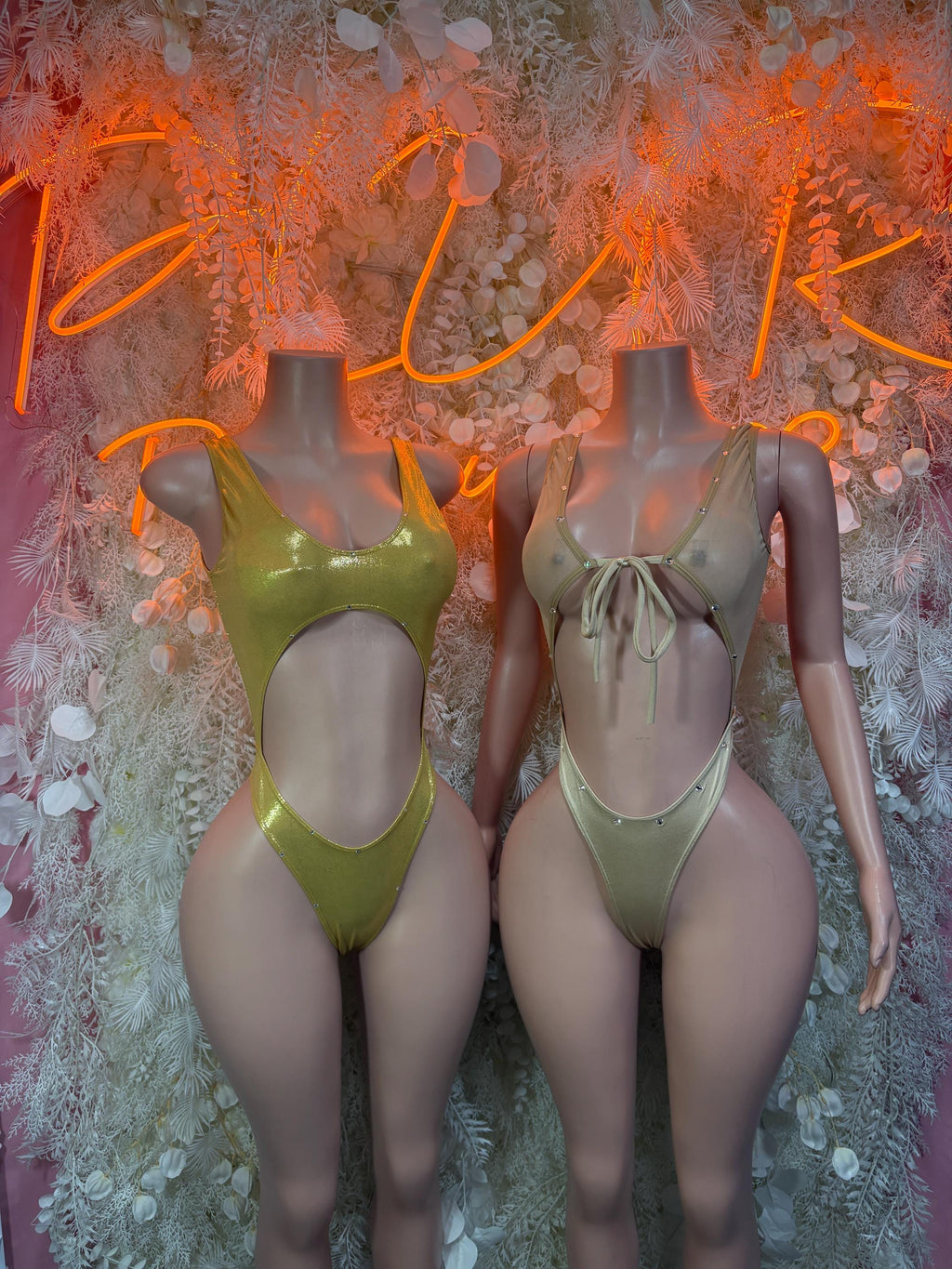 Gold rhinestone one-piece bodysuit on models, sleeveless with scoop neck and high-cut legs