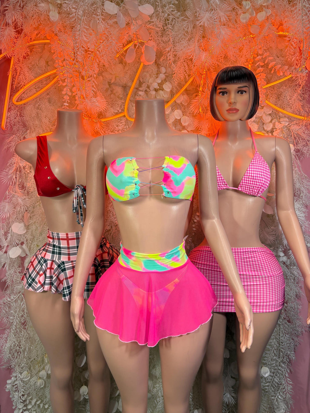 Pink ruffled mini skirt with rainbow neon check bikini top, two-piece rave outfit