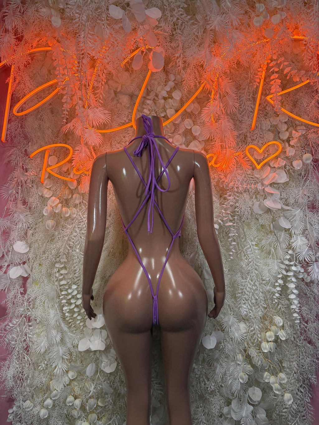 Purple fishnet one-piece swimsuit with lace-up open back and tied neck straps