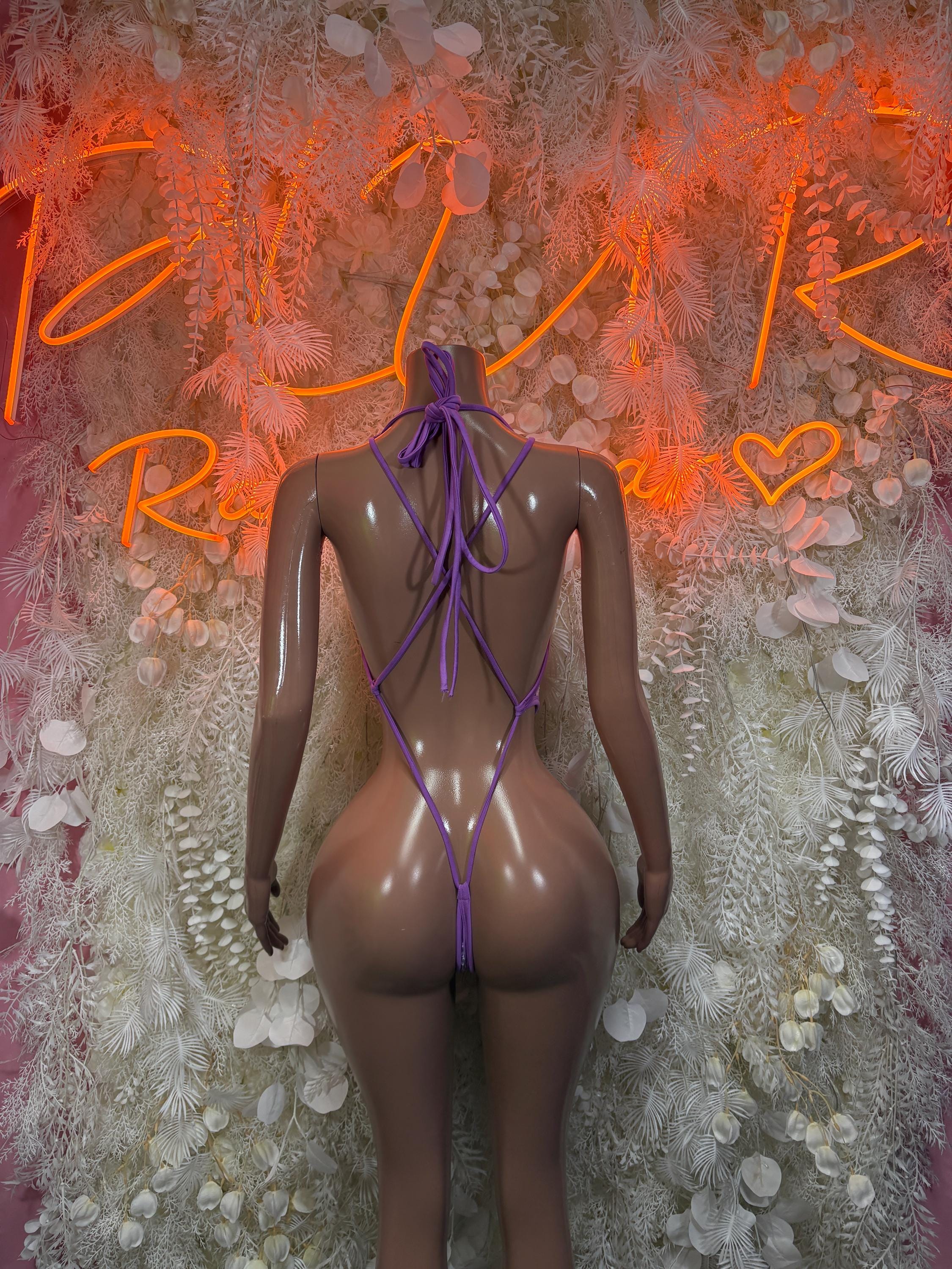 Purple fishnet one-piece swimsuit with lace-up open back and tied neck straps
