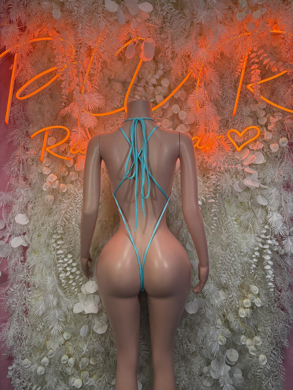 Teal fishnet one-piece with high-back crisscross ties and scoop neckline