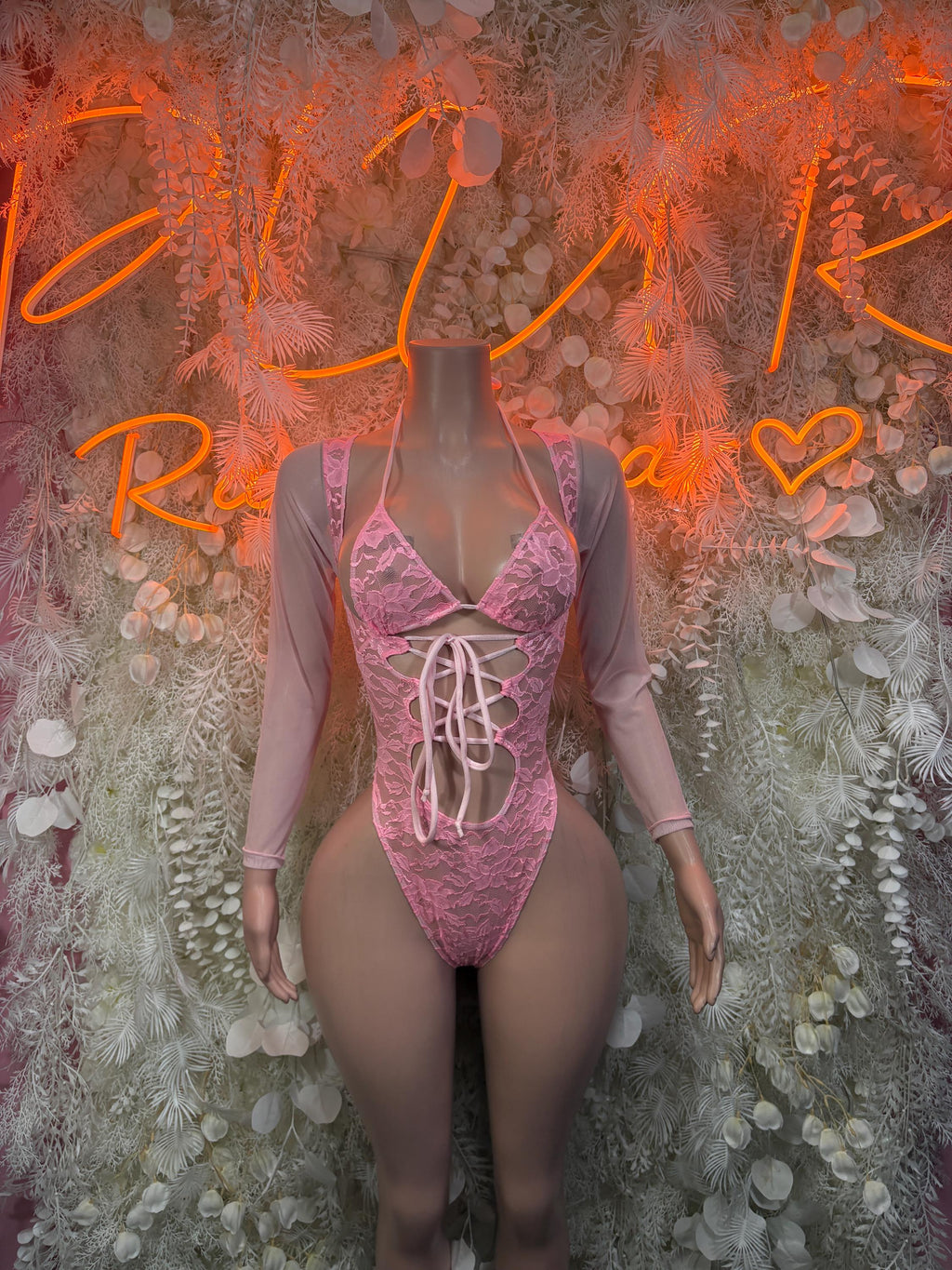 Pink lace long-sleeve bodysuit with corset lacing at center front