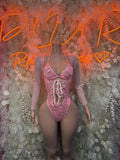 Pink lace long-sleeve bodysuit with corset lacing at center front