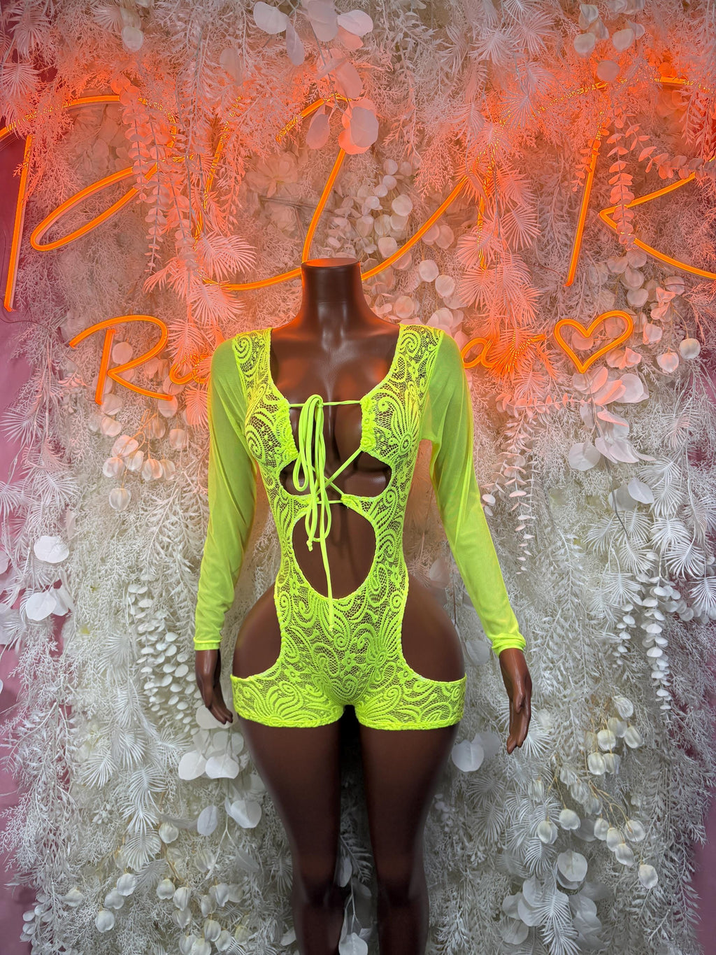 Neon green lace long-sleeve bodysuit with crisscross front lacing and cutouts