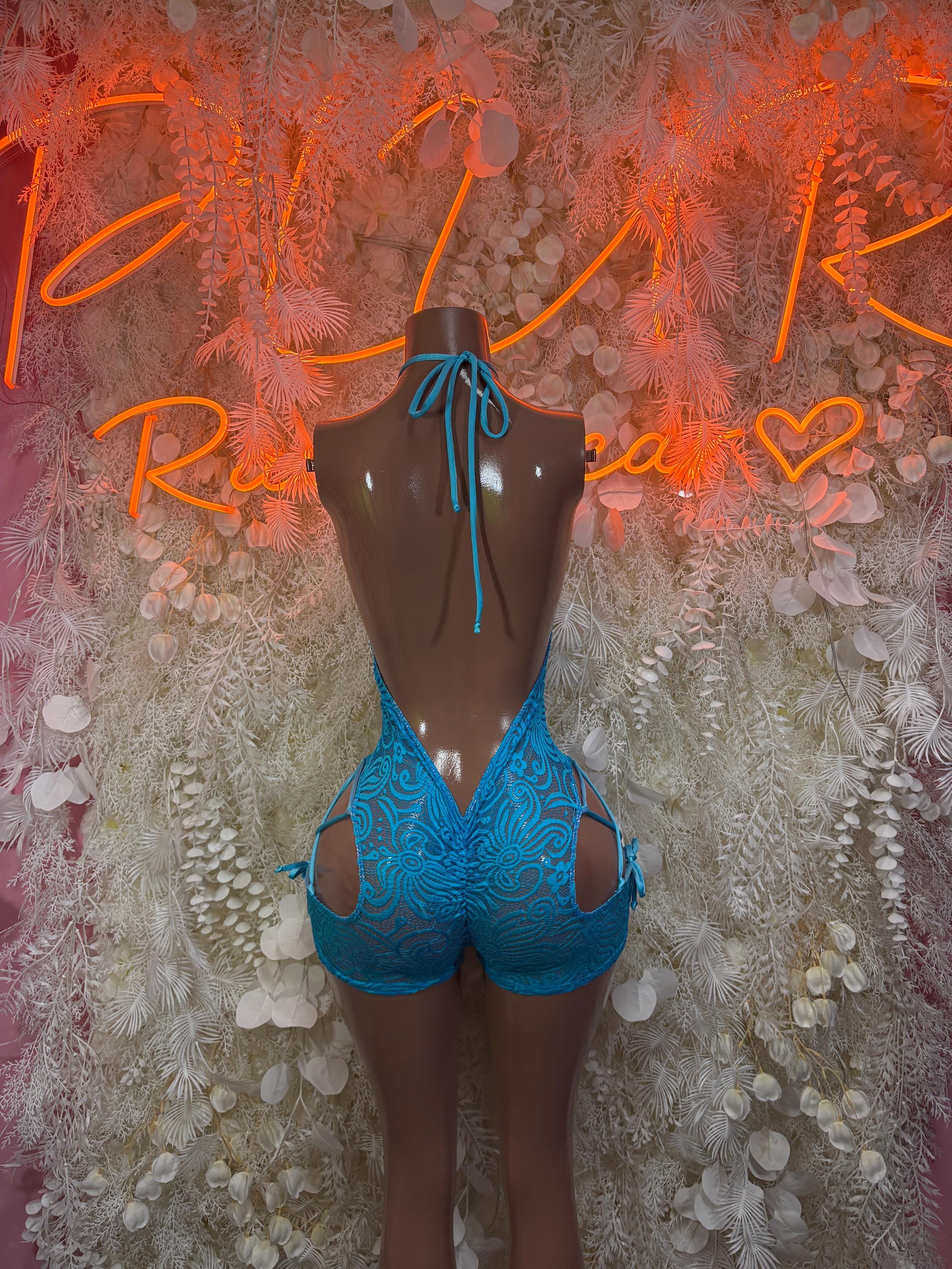Blue lace bodysuit with halter tie straps and lace-up back; open back cutouts