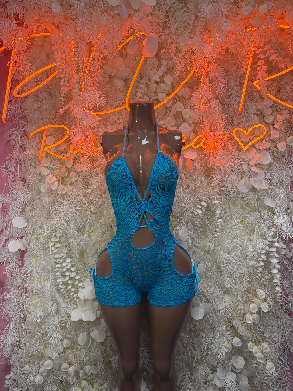 Blue lace bodysuit with halter straps, front cutouts, and thong-style bottom