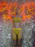 Yellow fishnet one-piece bodysuit with high-cut shorts and cross-mesh panels.
