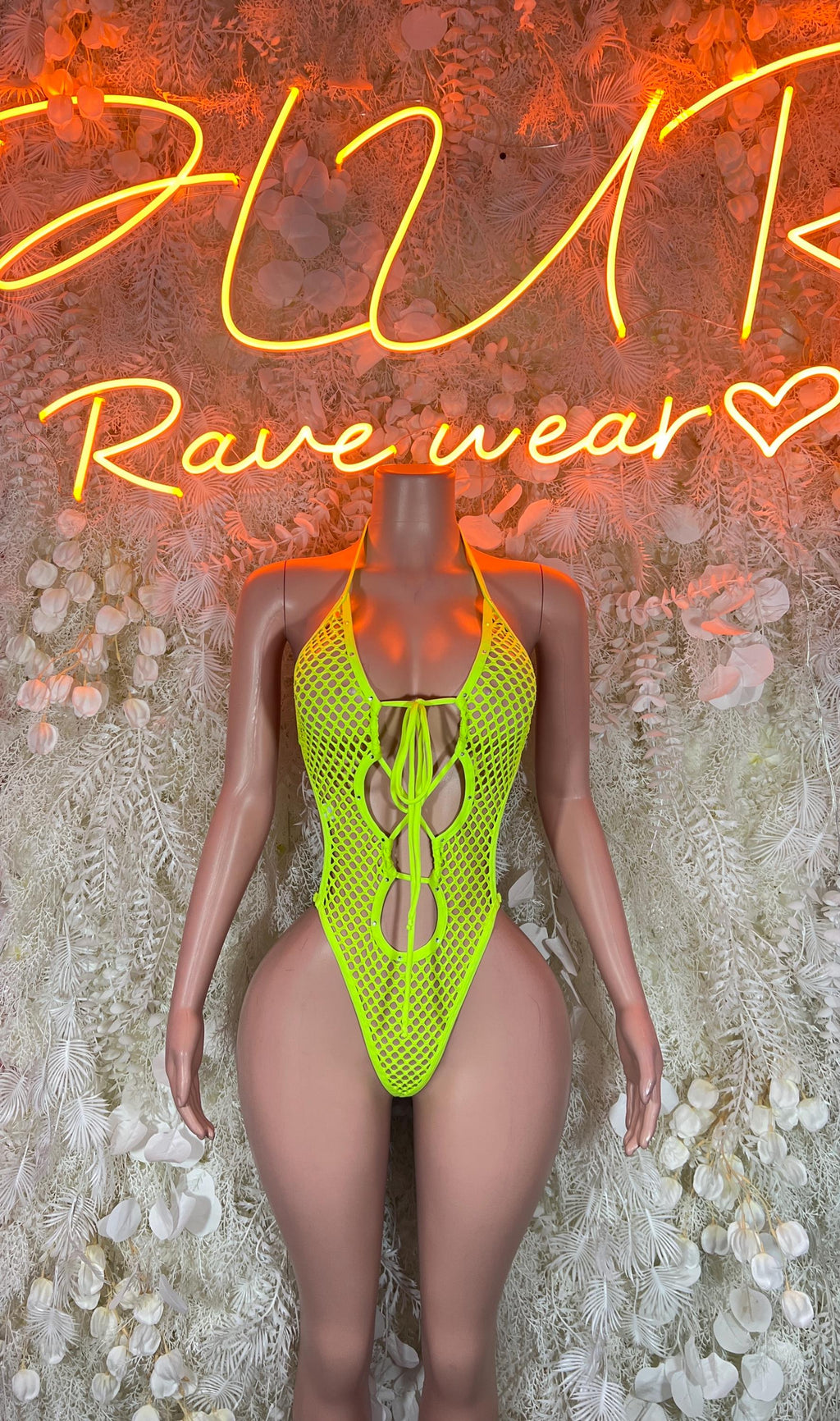 Neon green fishnet rave bodysuit with lace-up front and high-cut legs