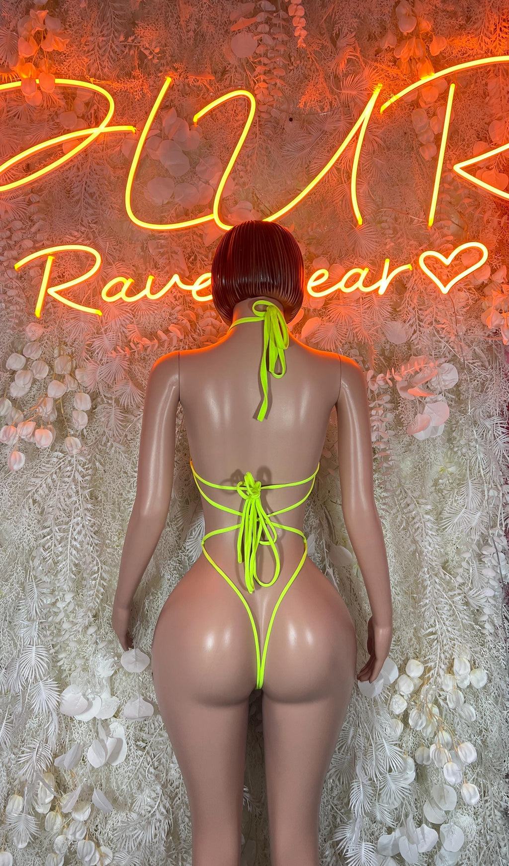 Neon green fishnet rave bodysuit with open back and lace-up tie closure