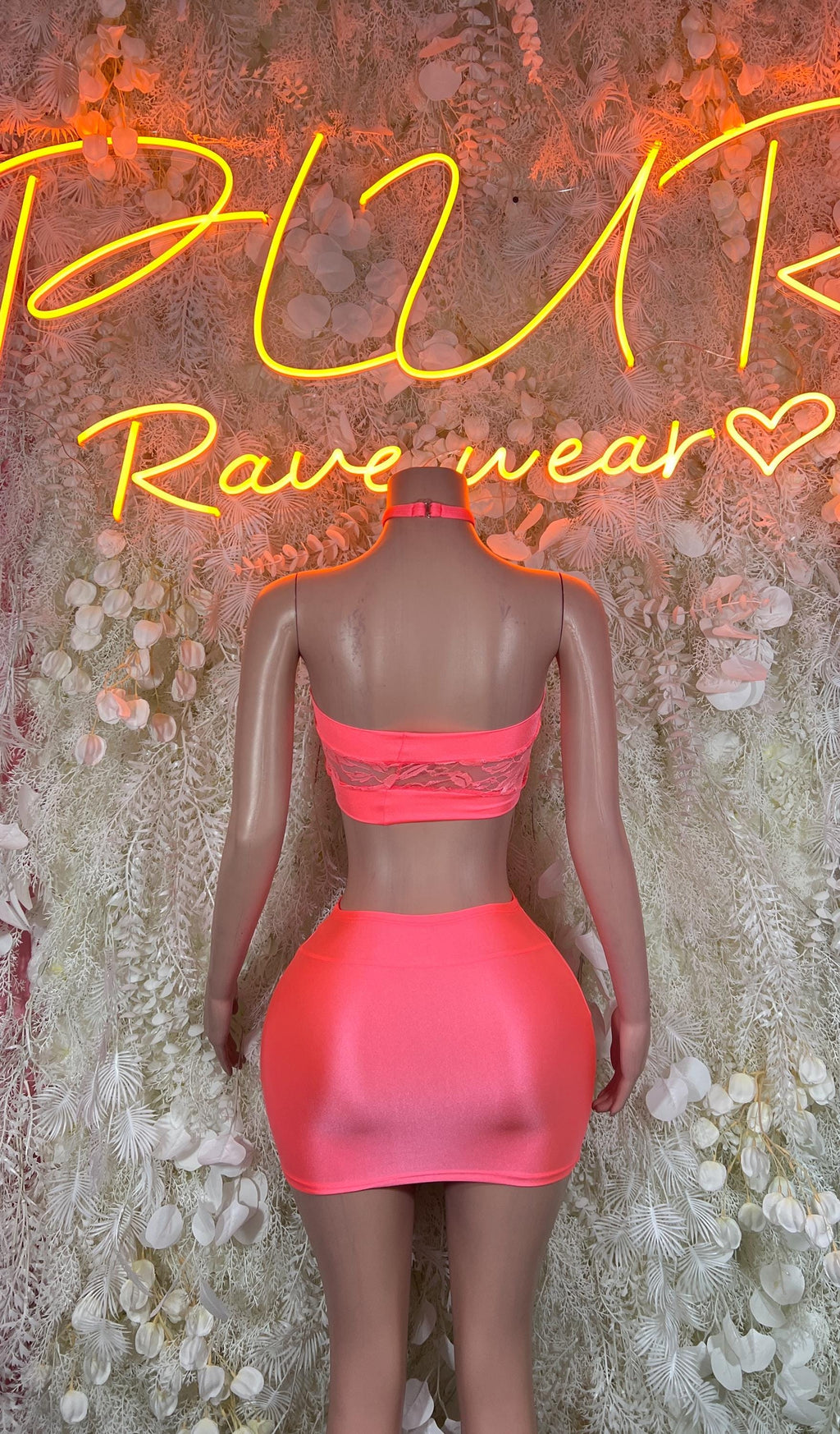 Neon pink bandeau top and mini skirt set, back view