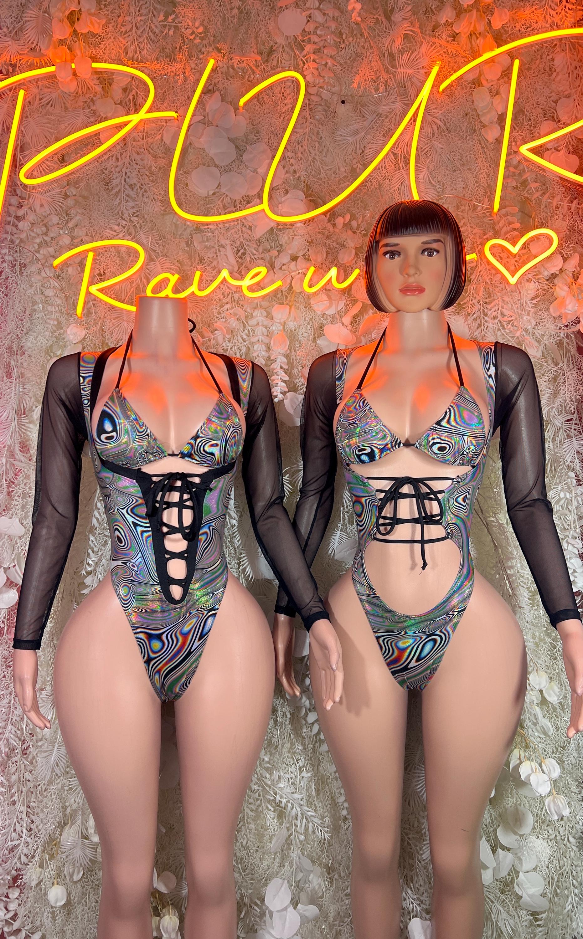Rave bodysuit on model: black long sleeves, lace-up front, multicolor metallic print