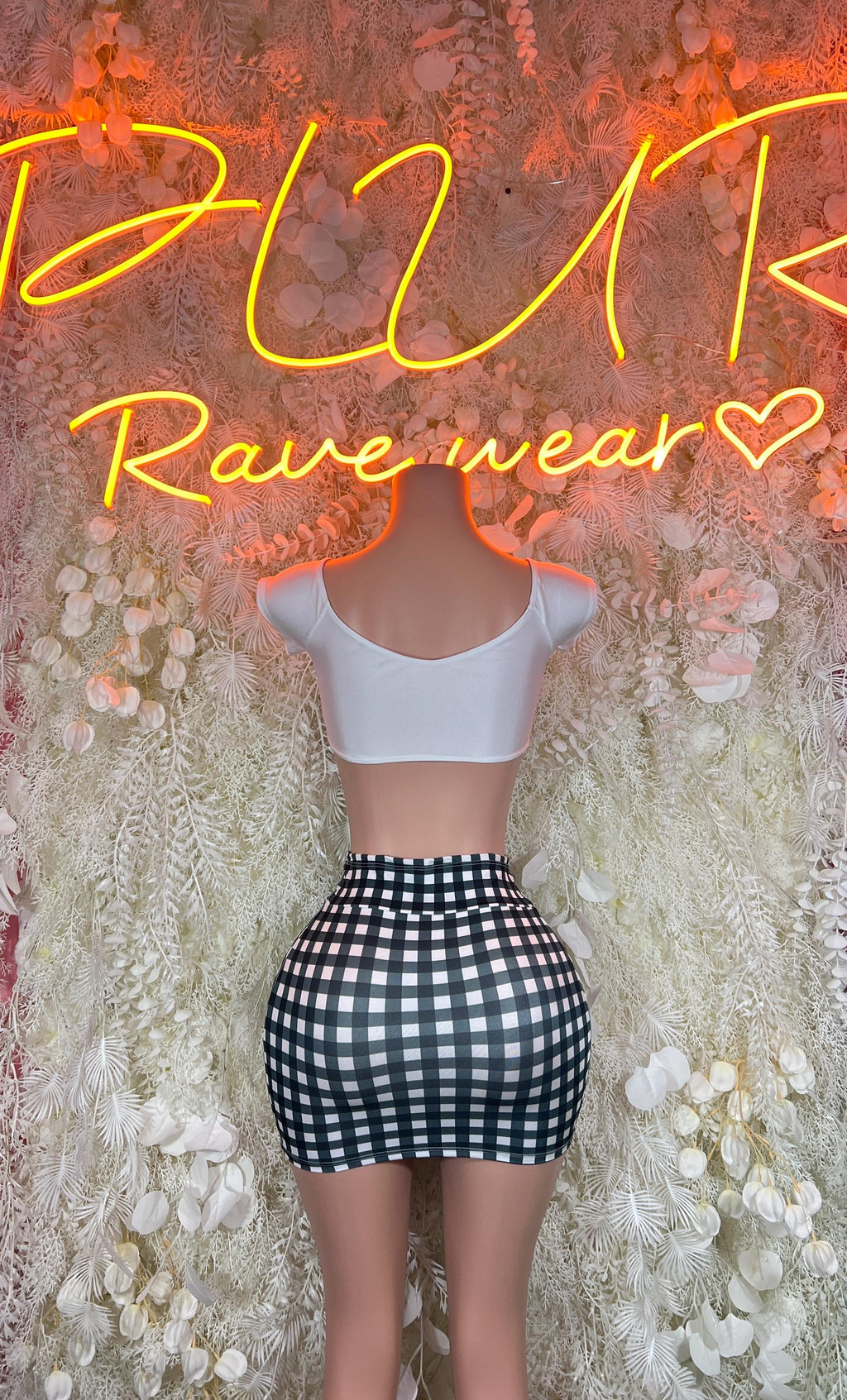 Two-piece festival set: light open-back crop top and black-and-white check mini skirt