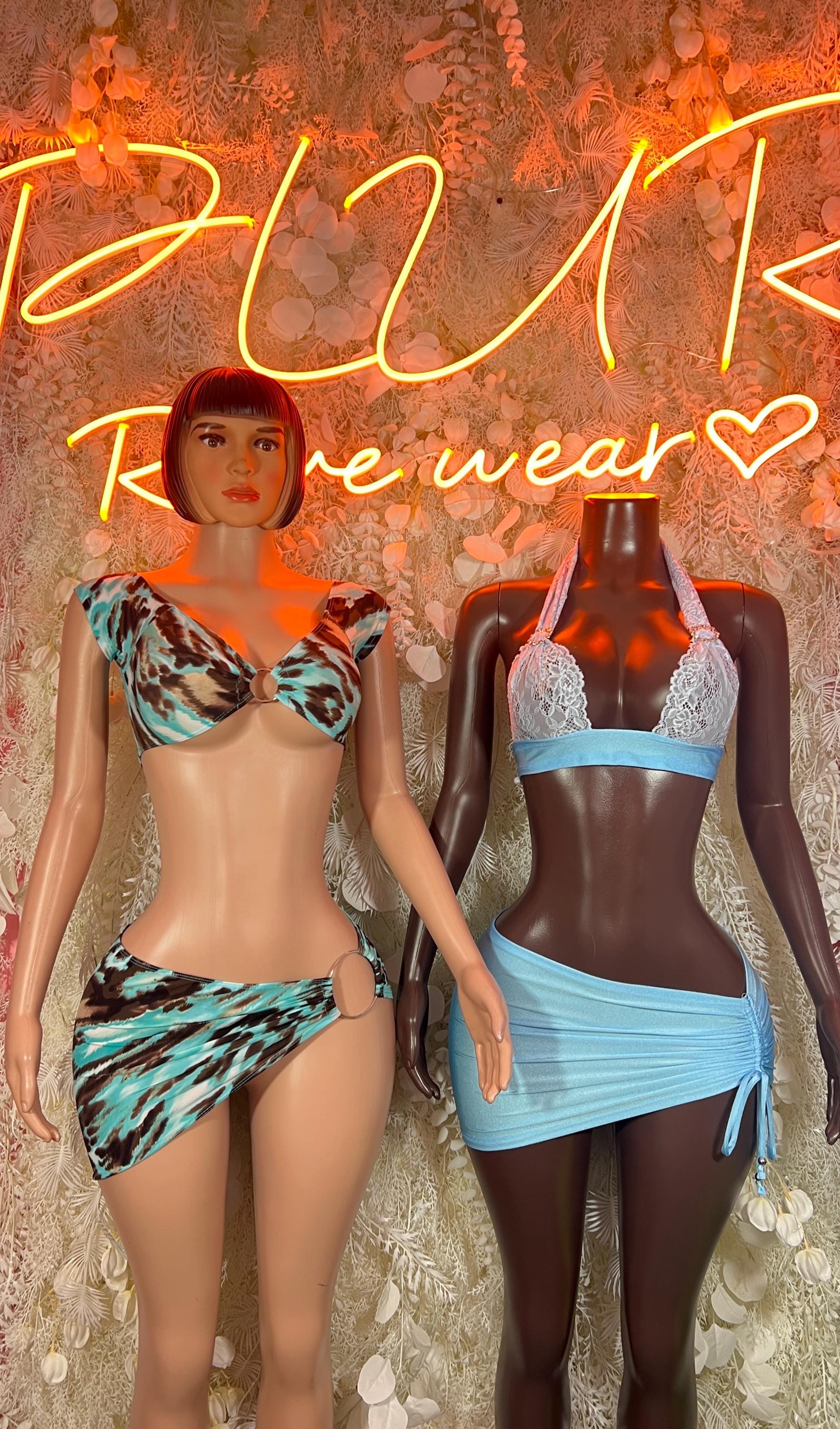 Blue lace two-piece skirt set on mannequin, bra top with matching tied mini skirt